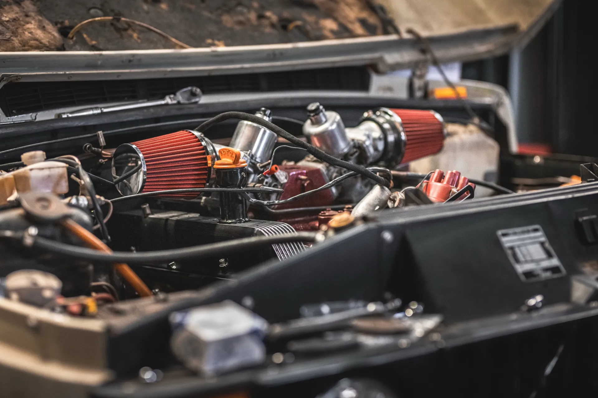 Engine bay of a car with the bonnet raised in a workshop