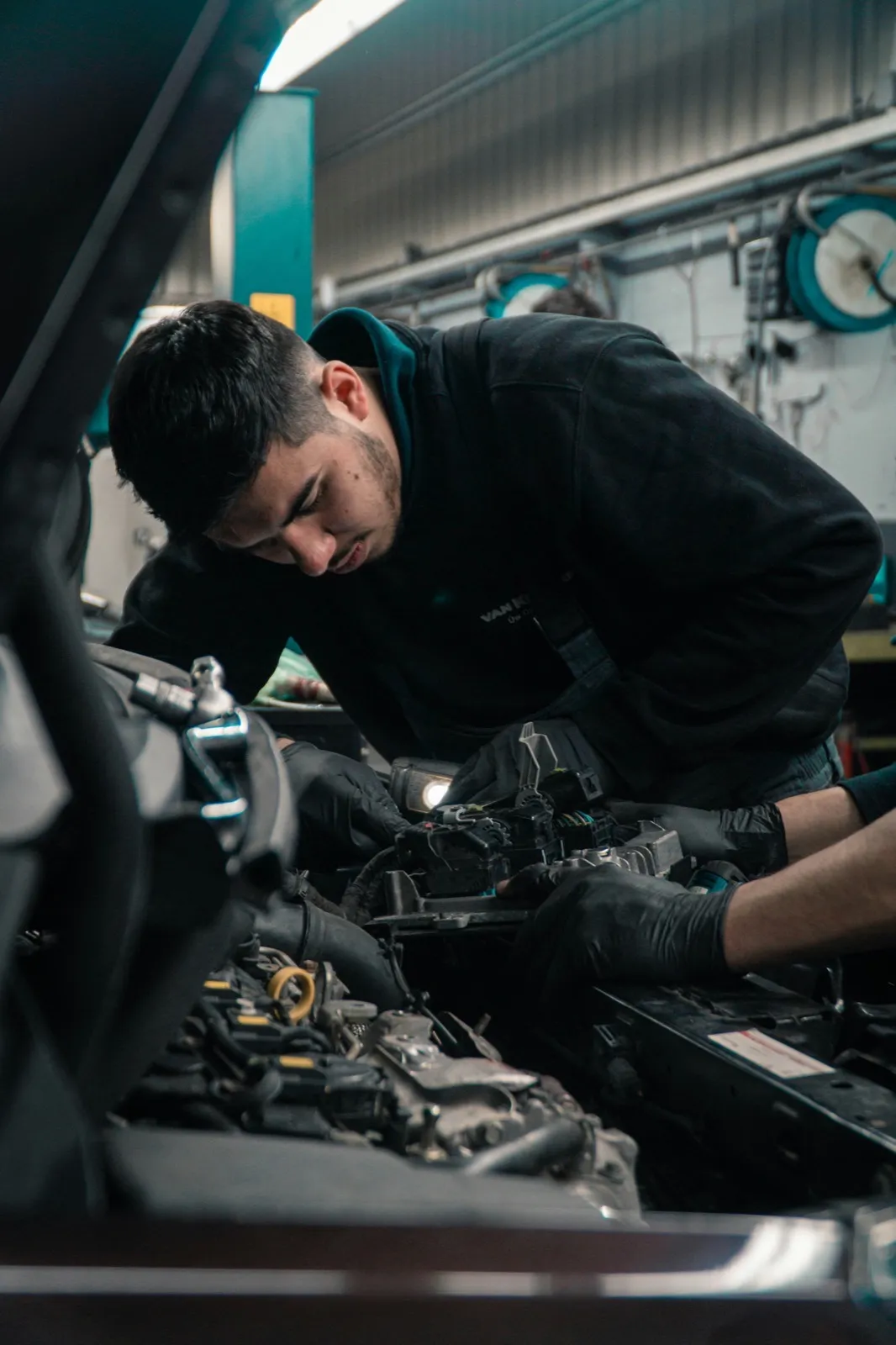 Mechanic working on a vehicle in a garage